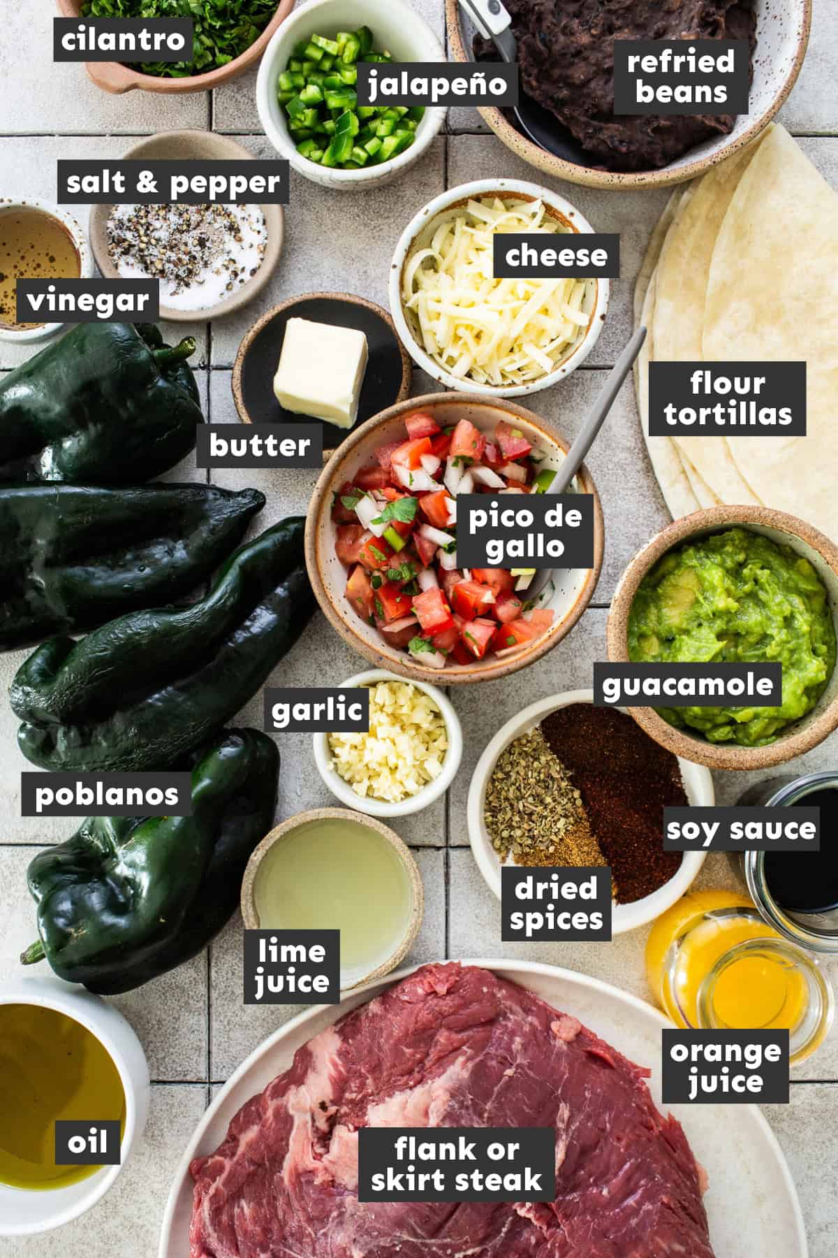 Ingredients for carne asada burritos laid out on a table ready to  use.