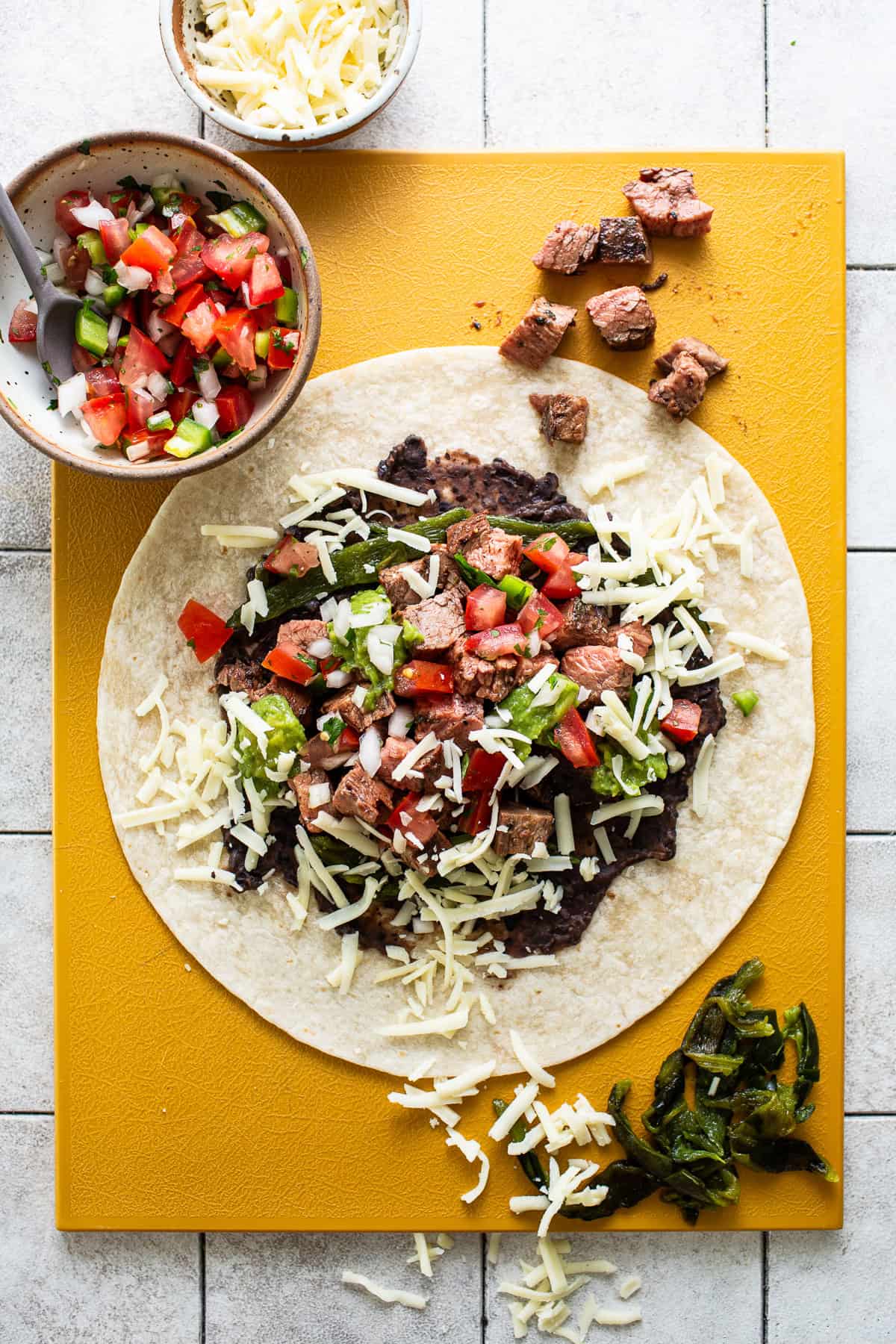 Warm flour tortilla with all toppings, carne asada, poblano peppers, and cheese.