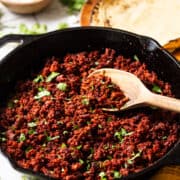 Seasoned Mexican chorizo in a skillet garnished with cilantro ready to eat in tacos, eggs, and more.