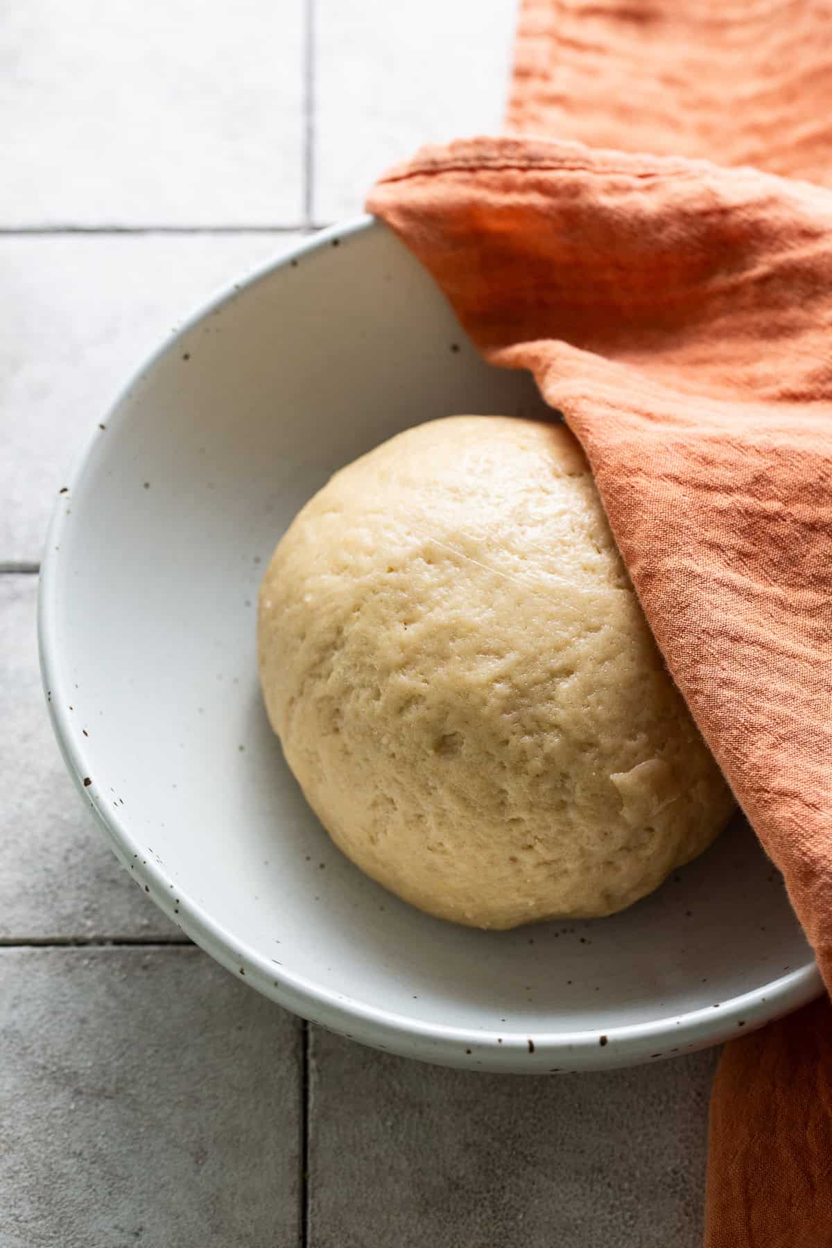 Kneaded dough for gorditas de azucar formed into a smooth ball resting in a bowl.