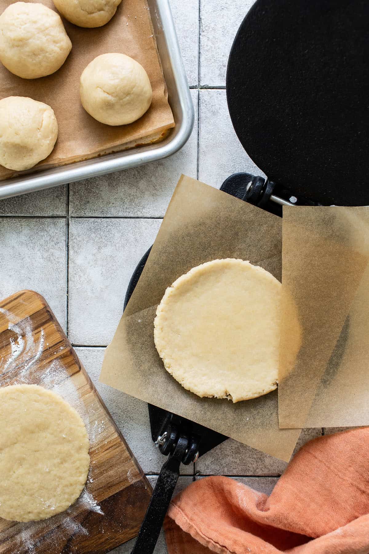 A tortilla press is used to shape the dough into 5 inch wide gorditas.