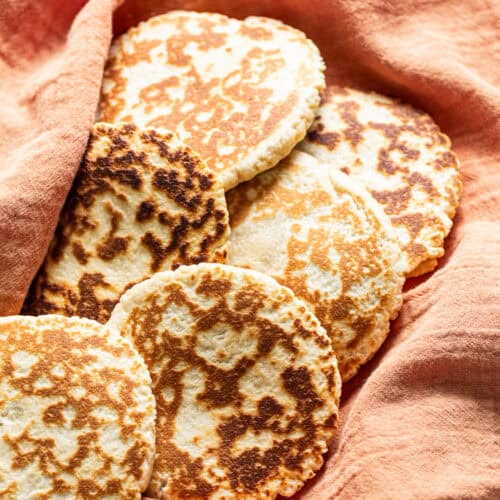 Gorditas de azucar (Mexican griddle cakes) wrapped in a clean kitchen towel ready to eat.