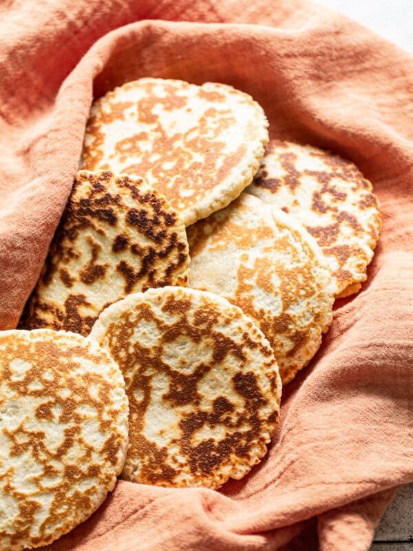 Gorditas de azucar (Mexican griddle cakes) wrapped in a clean kitchen towel ready to eat.