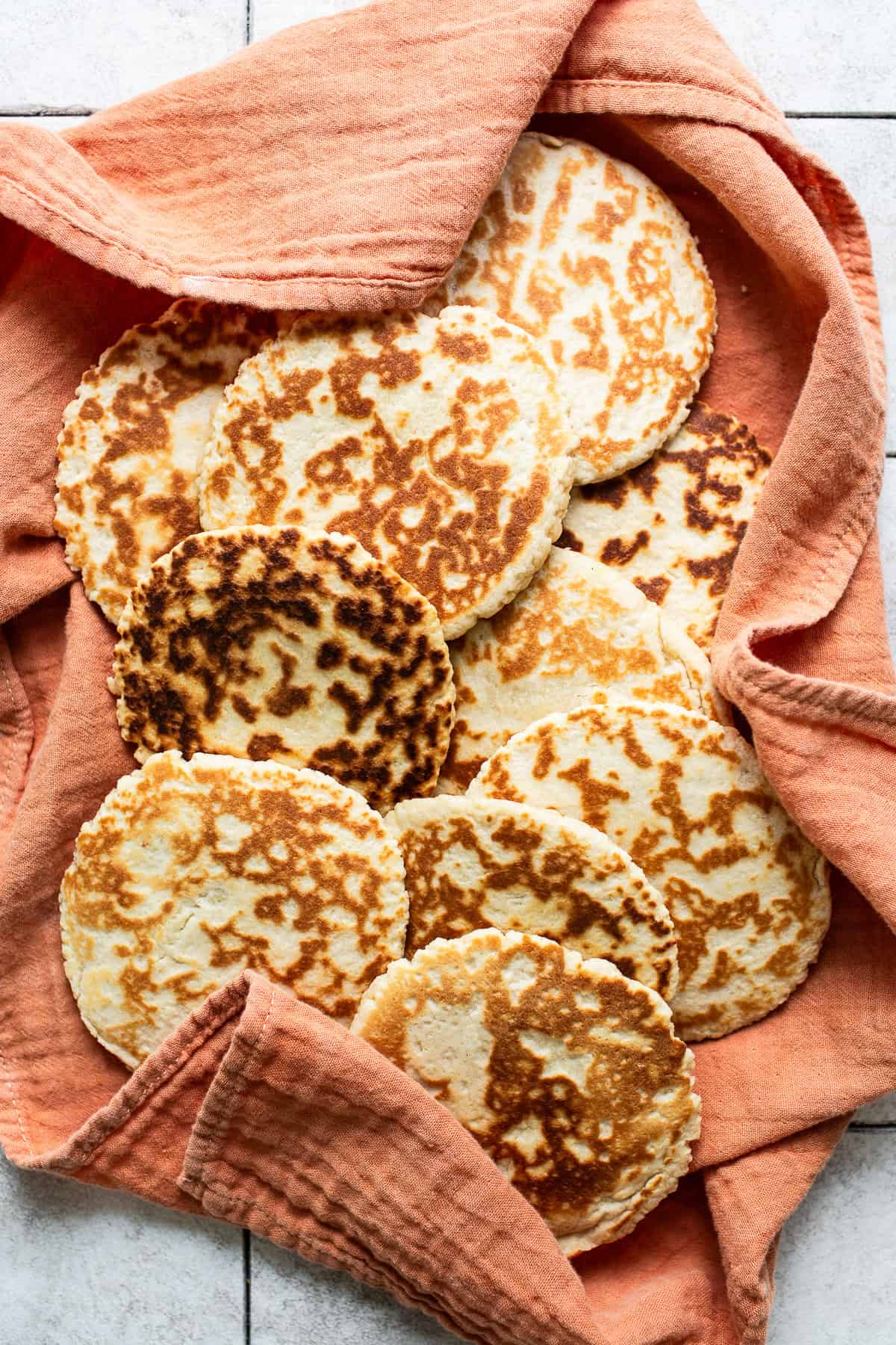 Cooked gorditas de azucar (also known as gorditas de harina) placed on a clean kitchen cloth ready to eat.