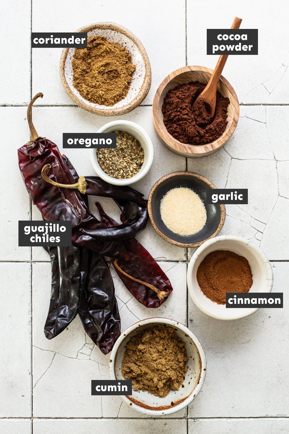 Ingredients in homemade chili powder on a table.