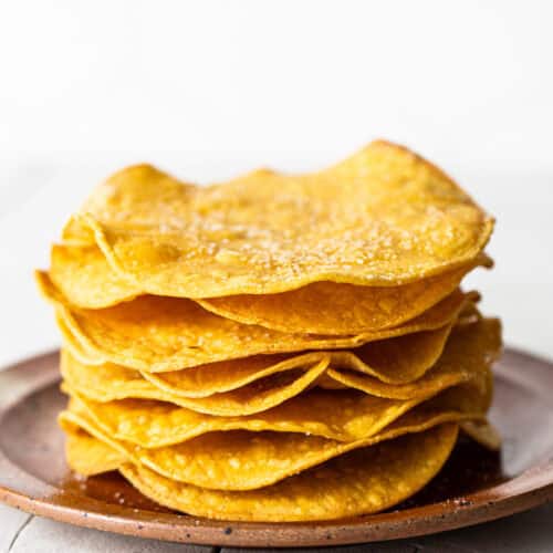 Homemade tostada shells on a plate ready to be served.