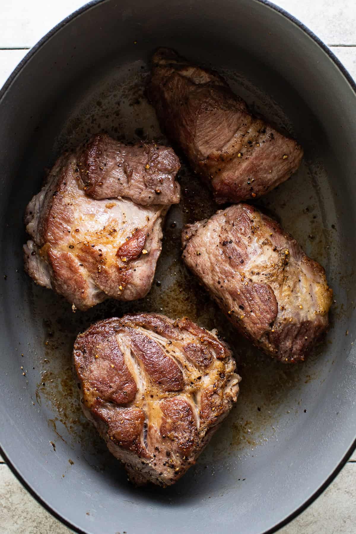 The seared meat for pozole in a large pot or Dutch oven.