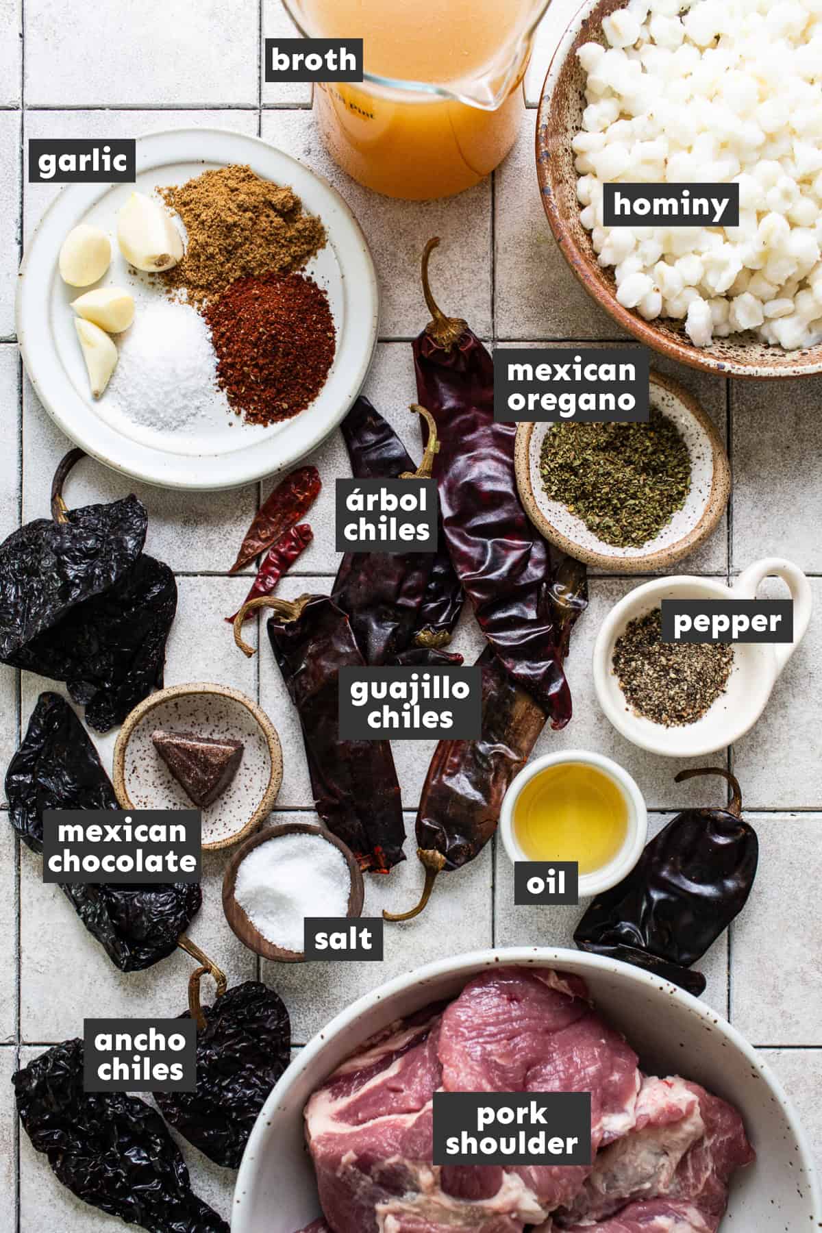 All ingredients needed for pozole rojo laid out on a table ready to use.