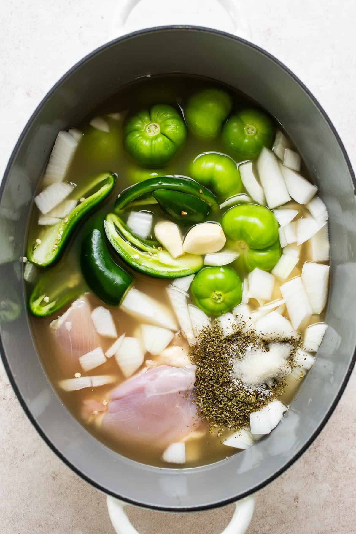 A large Dutch oven filled with ingredients for pozole verde is ready to bring to a boil.