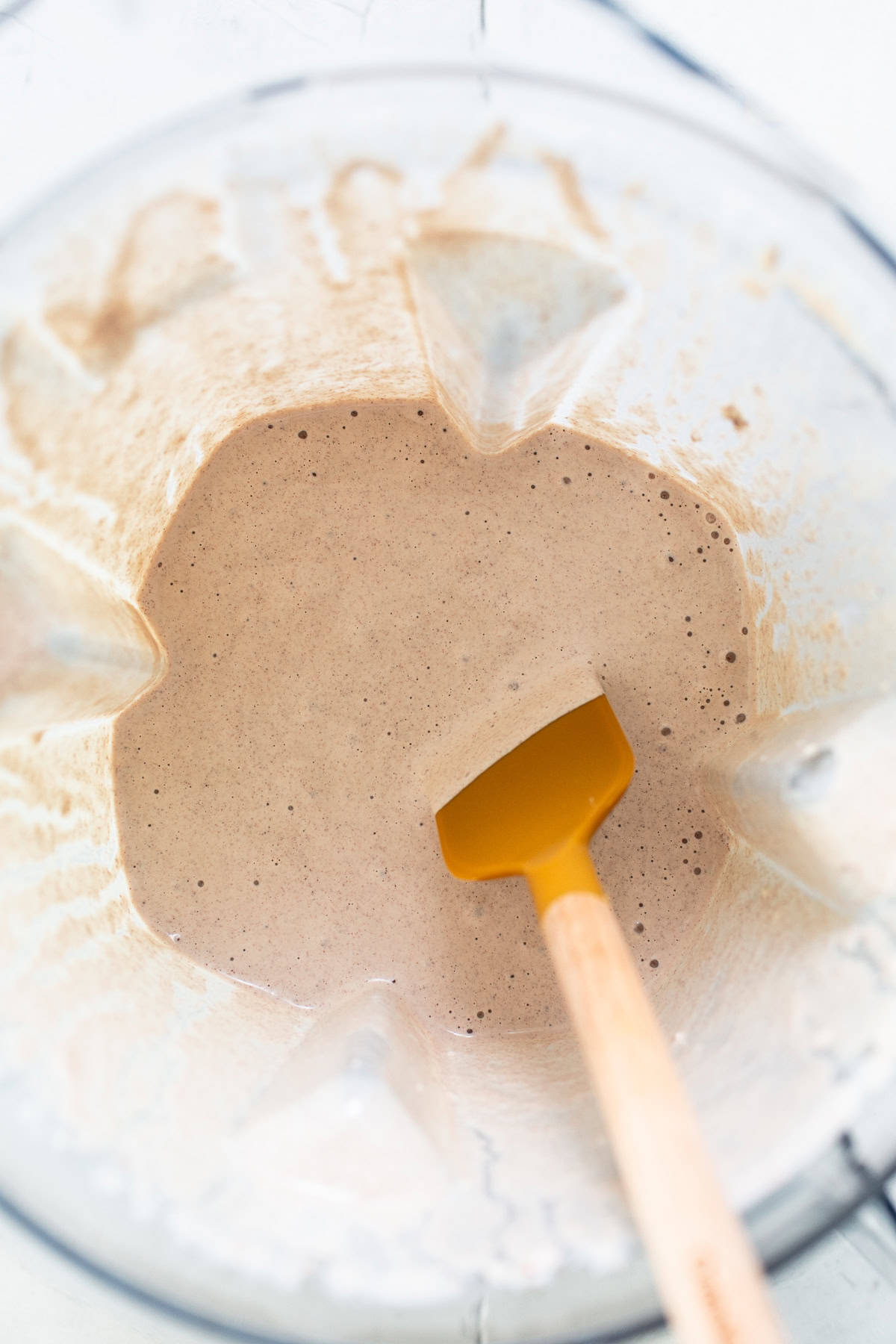  Blended mixture of toasted pecans, milk, vanilla, and salt in a blender.