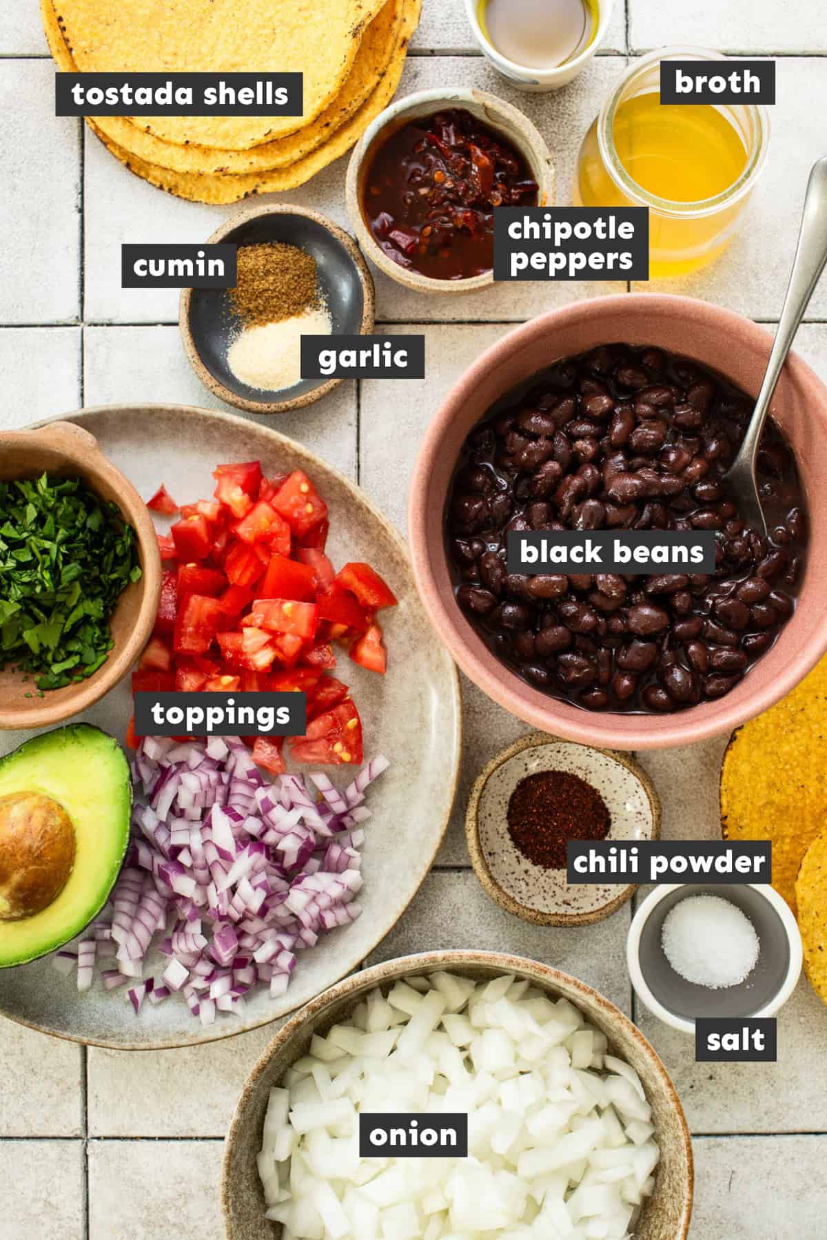 Prepped ingrediens for black bean tostadas on a table.