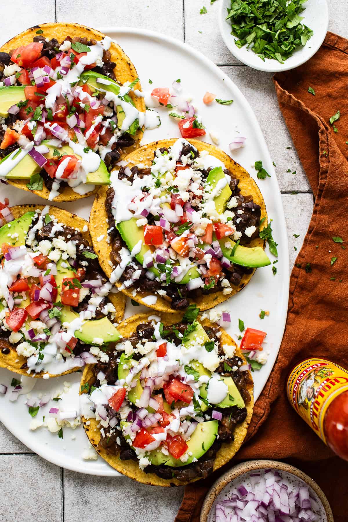 Black bean tostadas assembled and ready to serve with lots of toppings.