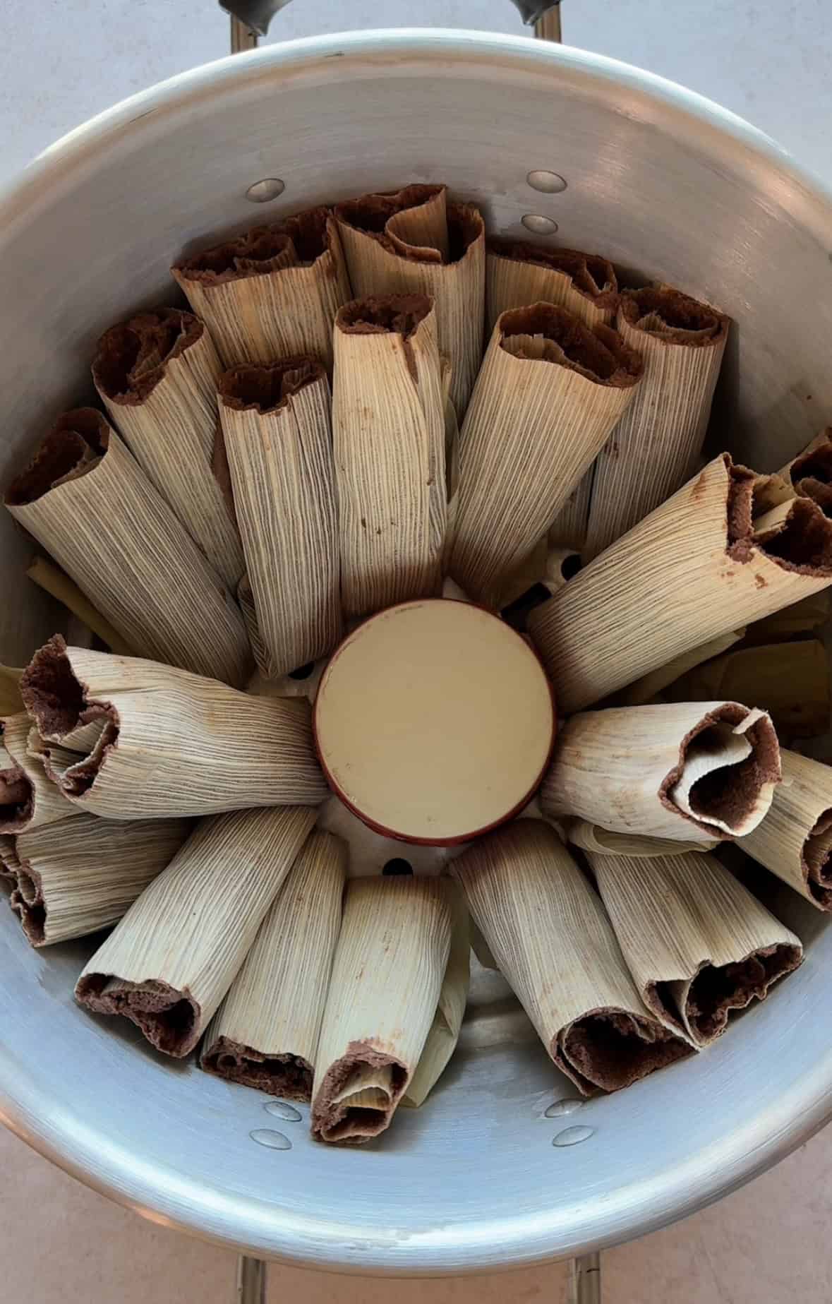 Chocolate tamales in a steamer pot ready to be cooked.