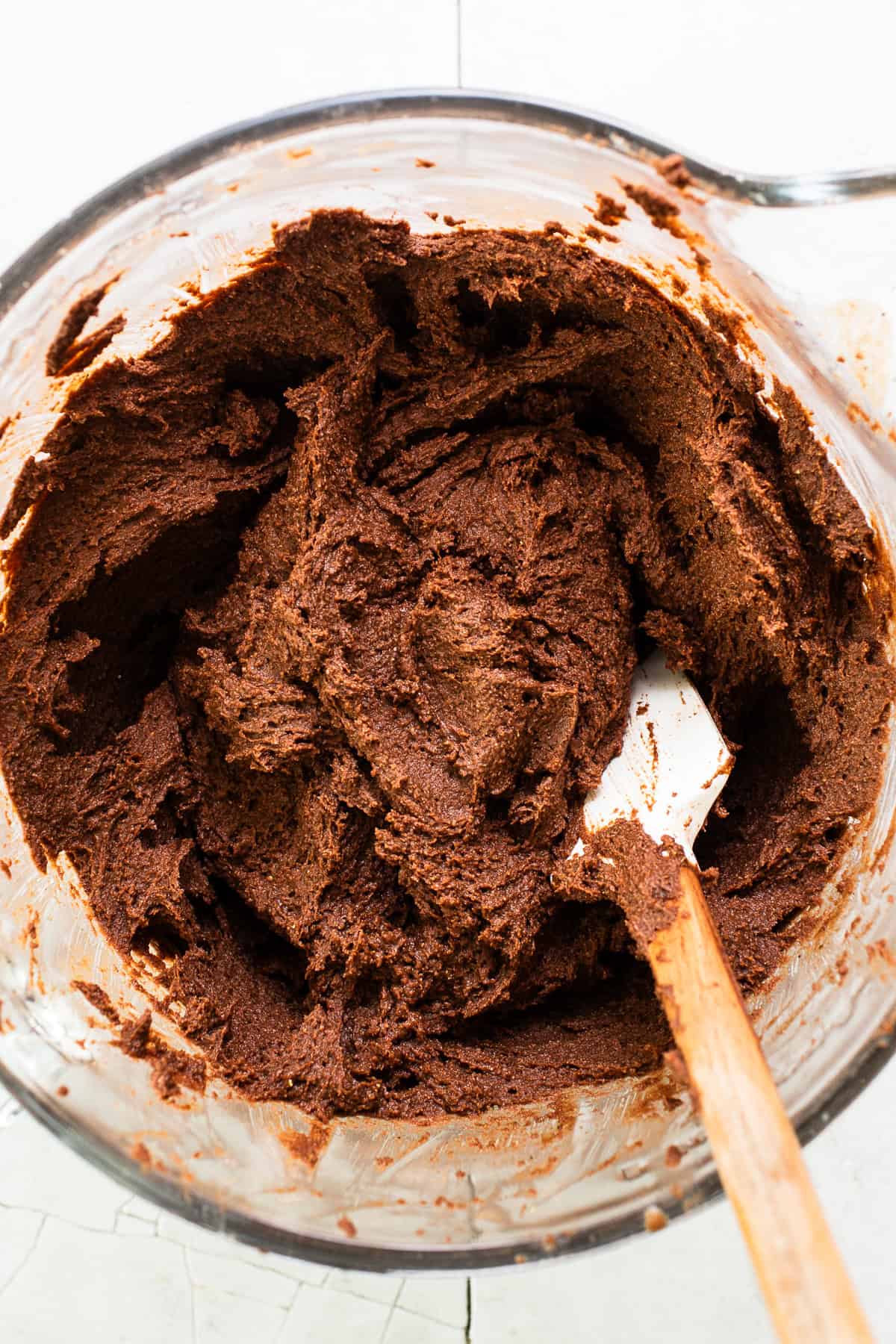 Chocolate masa dough for chocolate tamales in a stand mixer ready to be spread on corn husks.