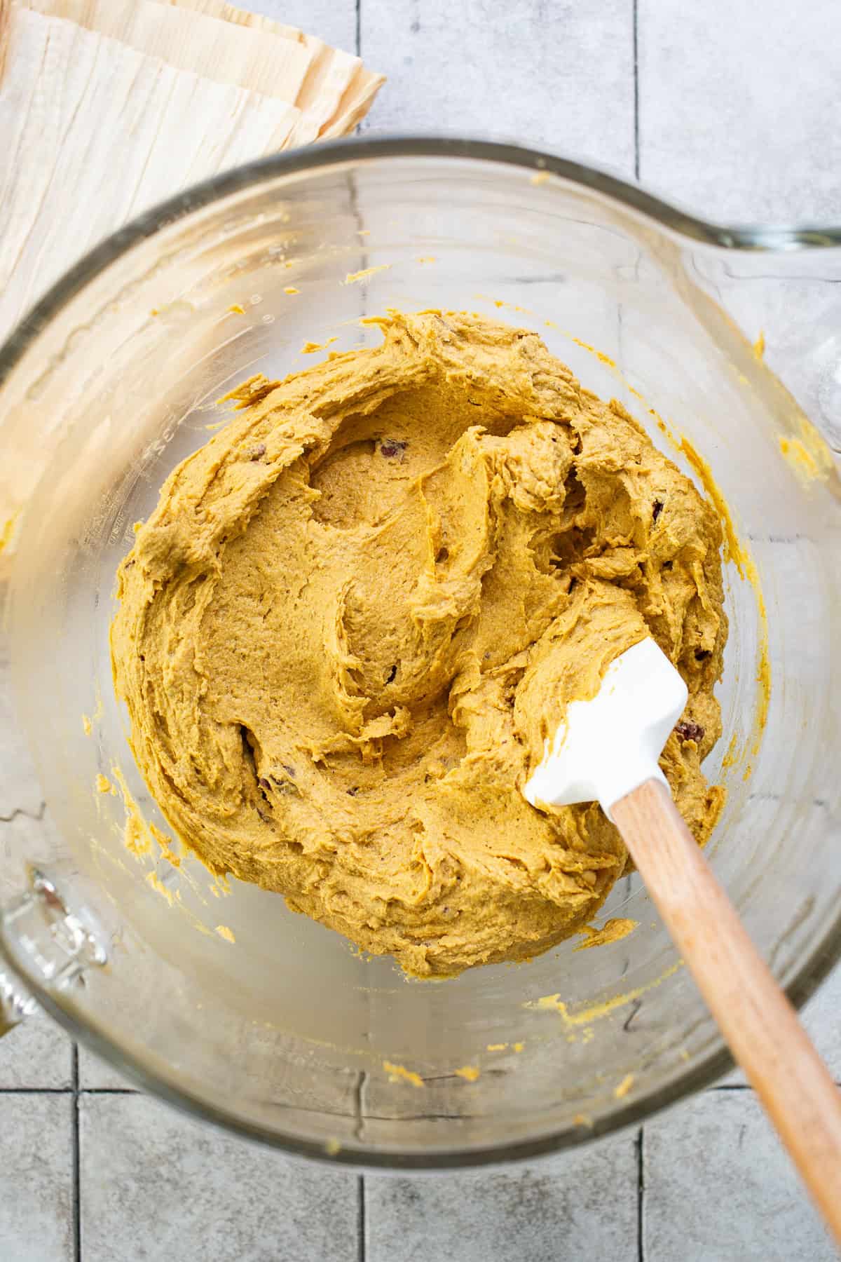 Pumpkin tamales masa dough in a large mixing bowl.