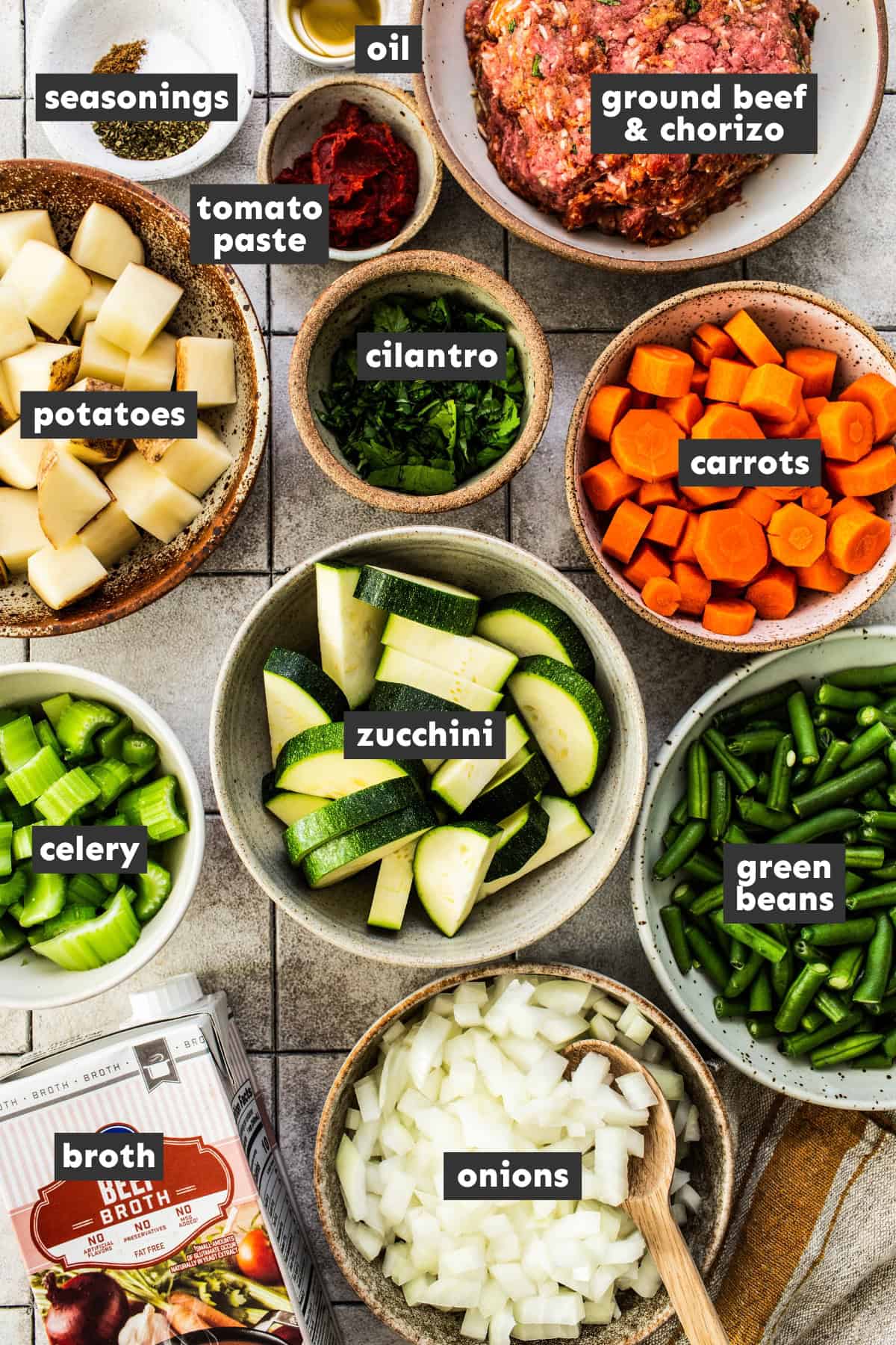 Prepped and chopped ingredients for albondigas soup on a table.