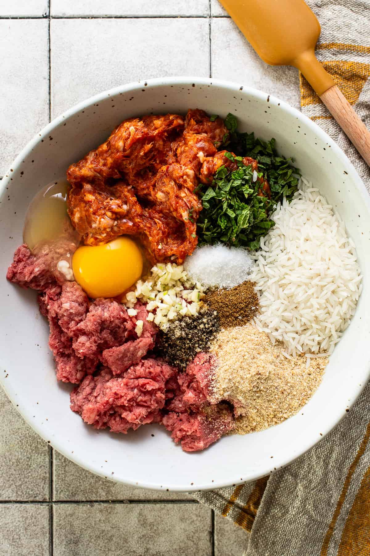 All the ingredients for albondigas (aka mexican meatballs) in a bowl.