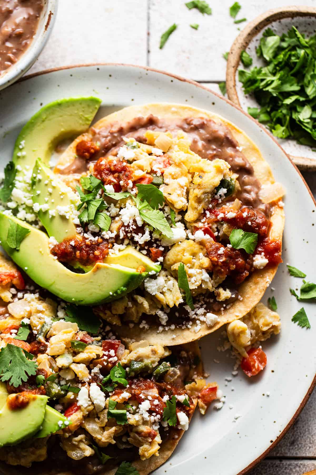 Homemade breakfast tostadas topped with queso fresco and salsa.