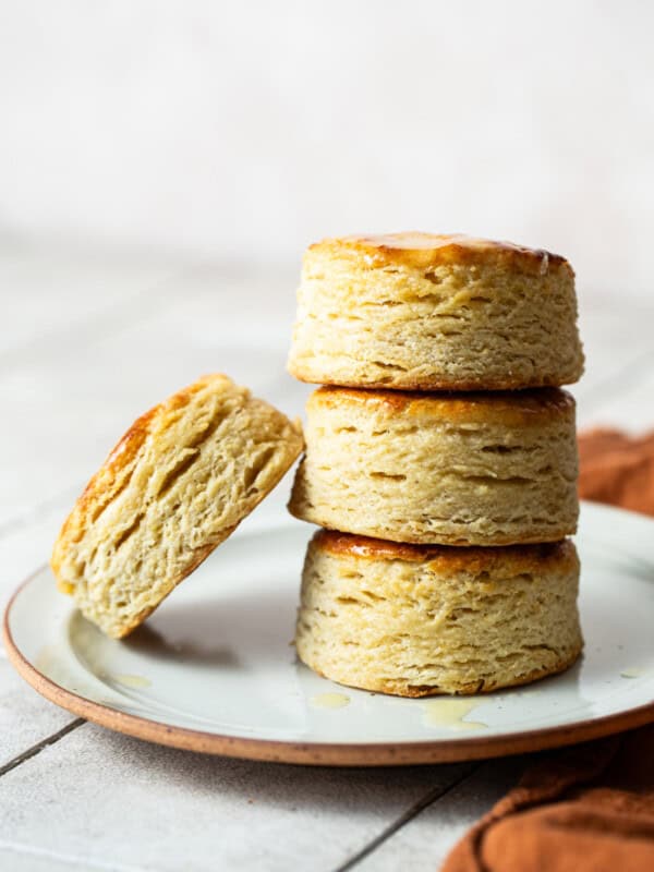 Masa harina biscuits stacked on top of each other on a plate.