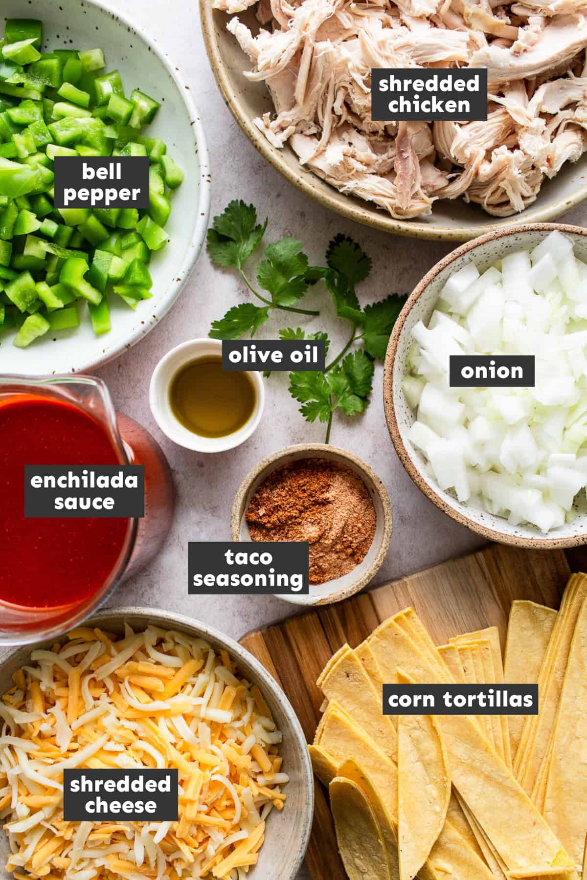 All of the ingredients for chicken enchilada skillet recipe set on a table ready to use.