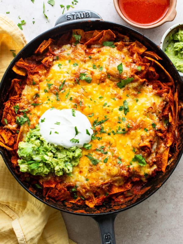 Chicken enchilada skillet topped with sour cream and ready to serve.