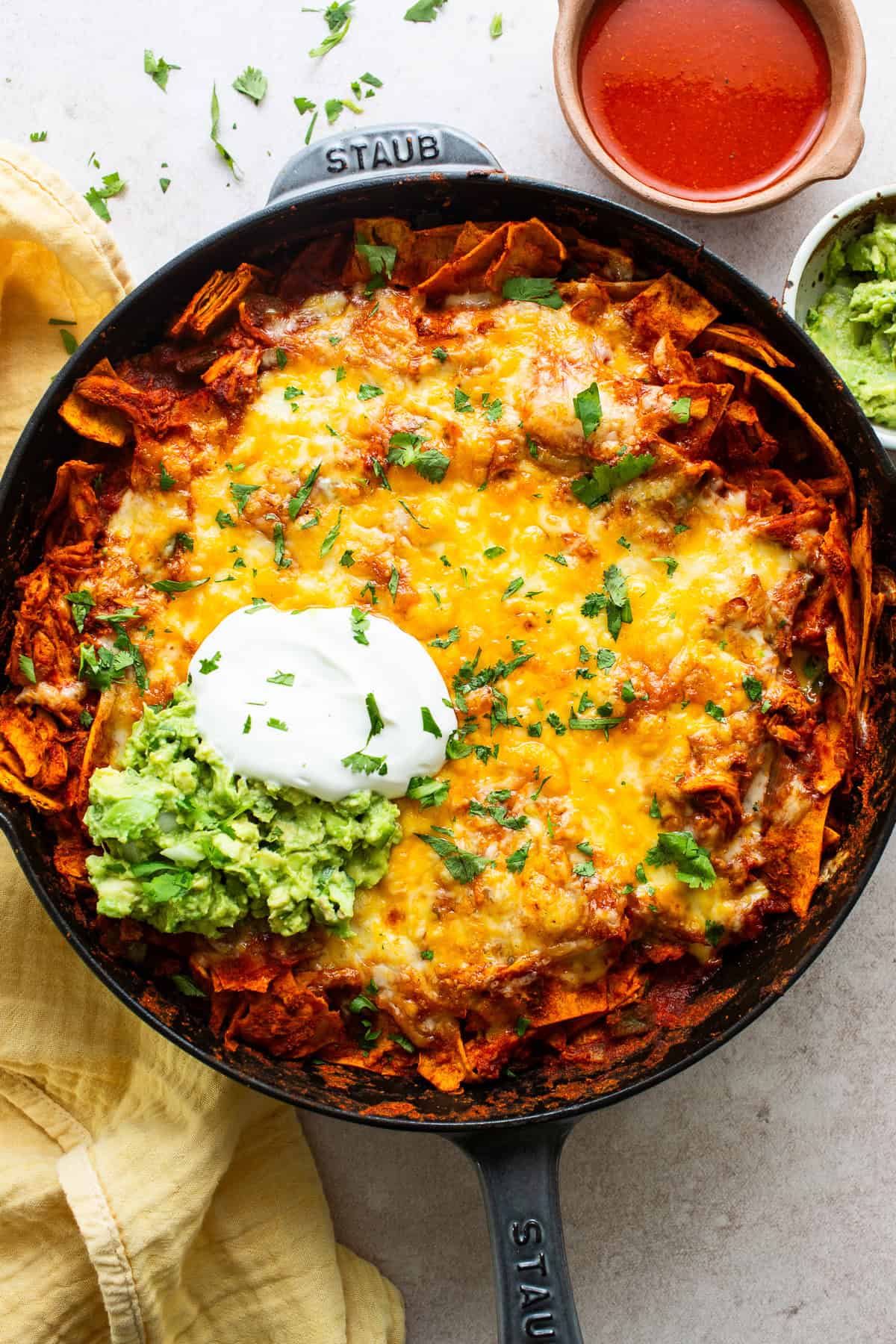 Chicken enchilada skillet topped with sour cream and ready to serve.