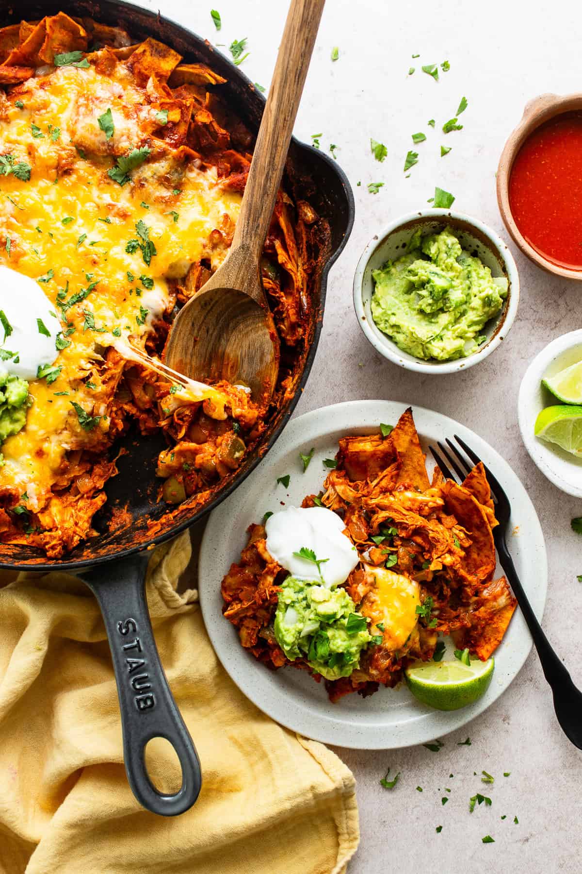 Baked chicken enchilada skillet being served onto a dinner plate.