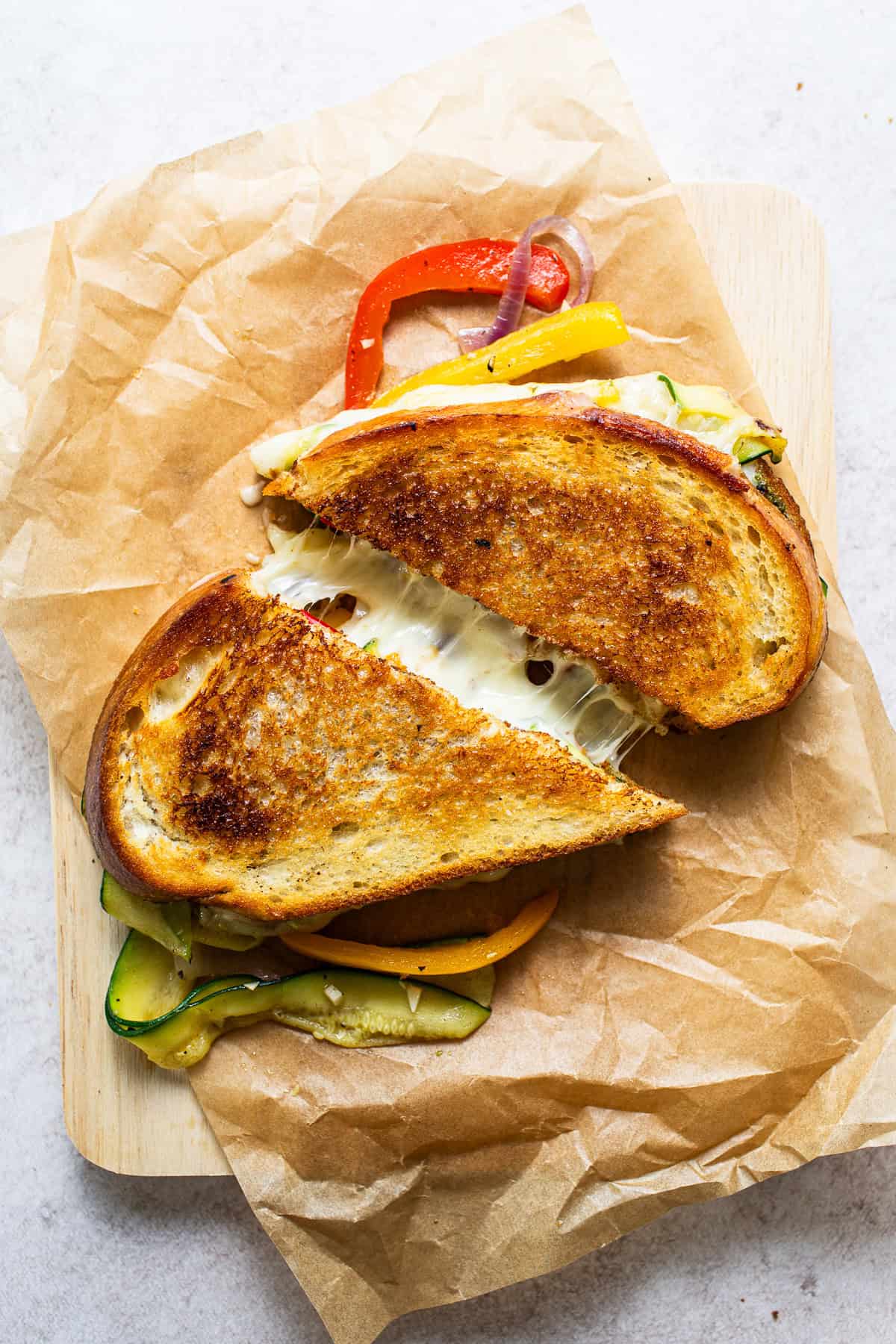 Fajita grilled cheese cut in half showing the cheese pull.