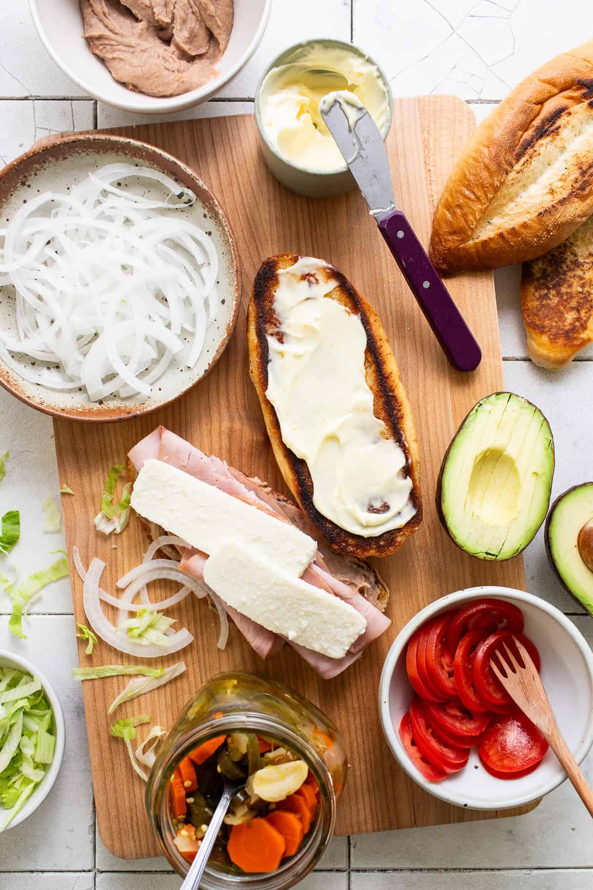 Start laying all of the fillings inside the bolio bread.