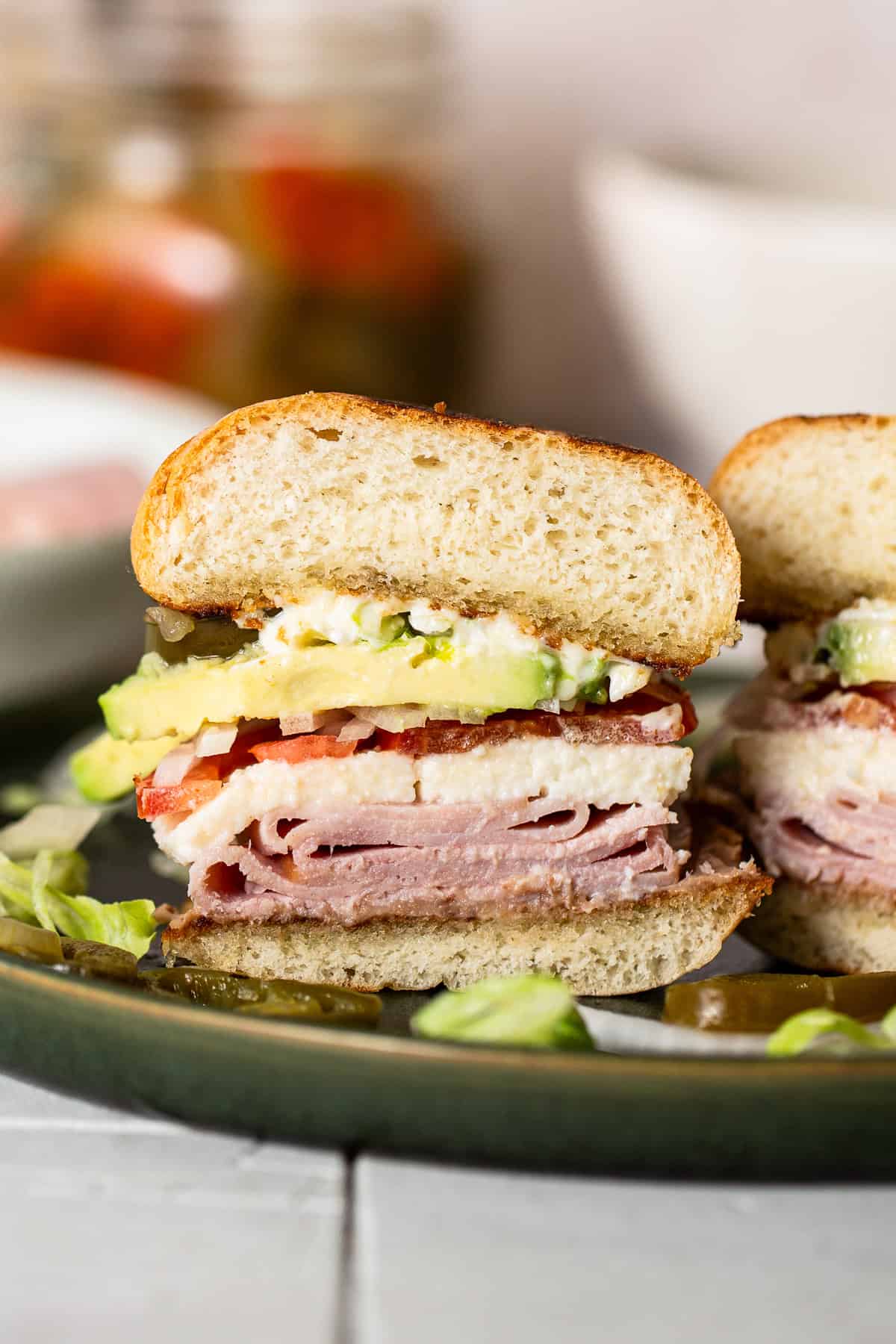 A torta de jamon cut in half, served on a plate, and ready to eat.