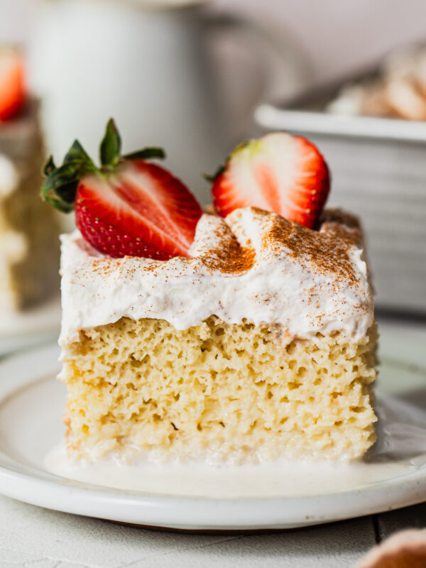 A slice of tres leches cake on a plate.