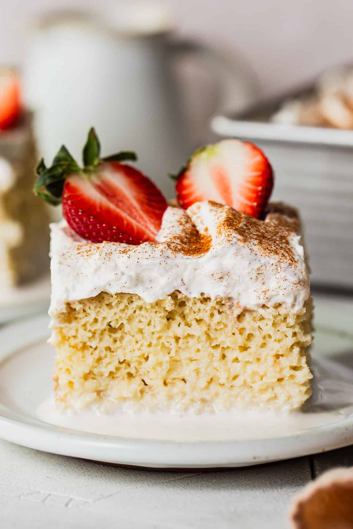 A slice of tres leches cake on a plate.